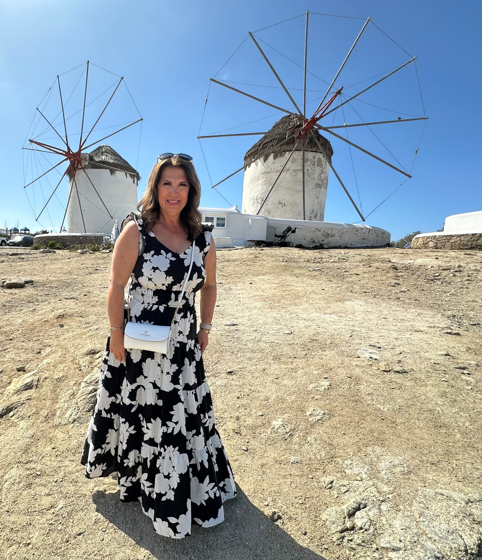 Paula H Benham, owner and international tour guide, in front of the Mykonos windmills